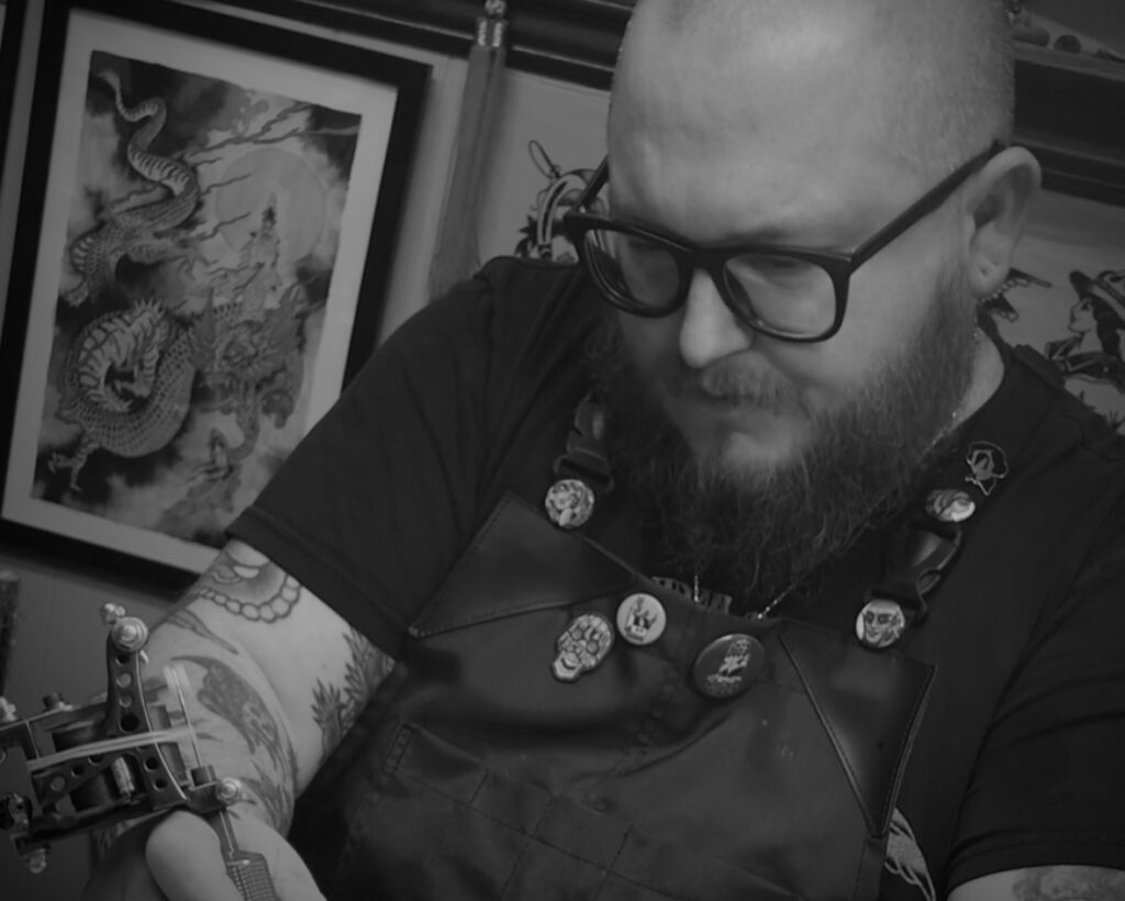 Tom Veling tattooing at Small World Tattoo, the best tattoo shops near me.