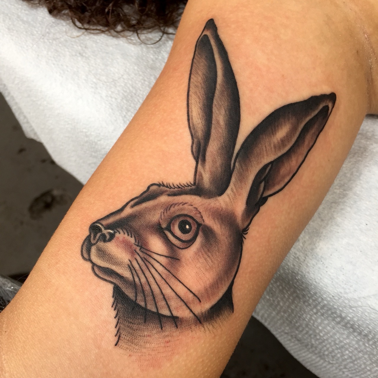Black and grey rabbit tattoo